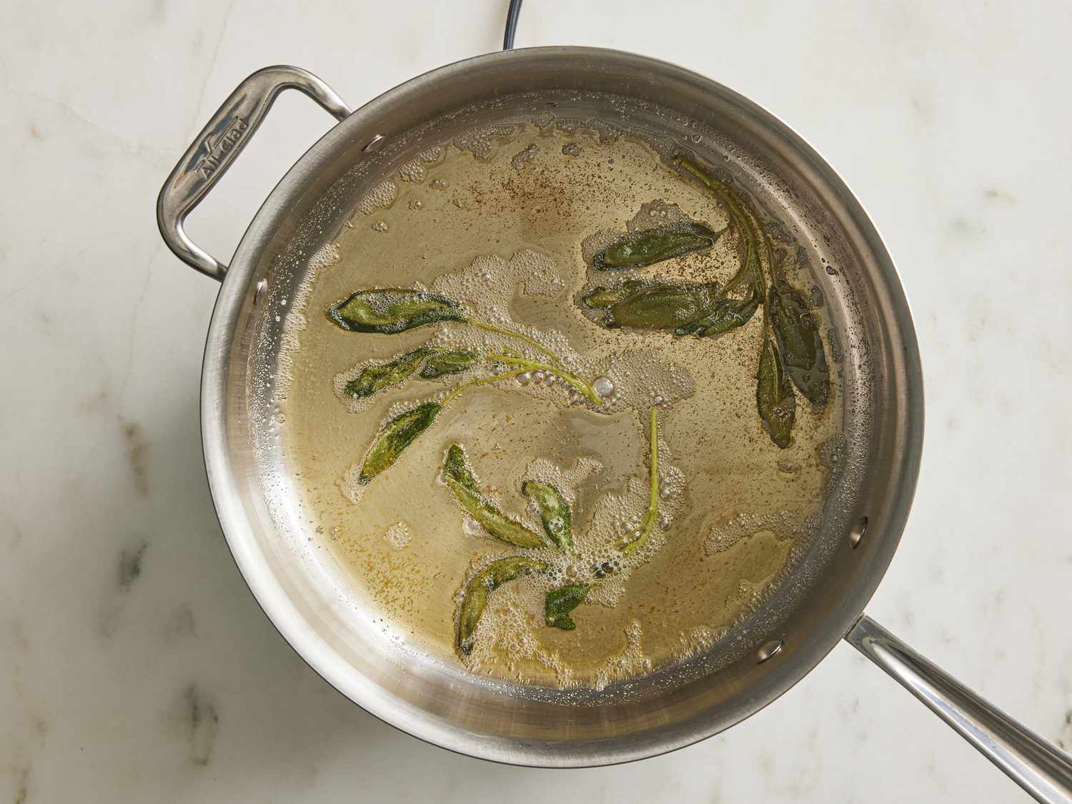 Sage leaves in a pan with foaming butter 