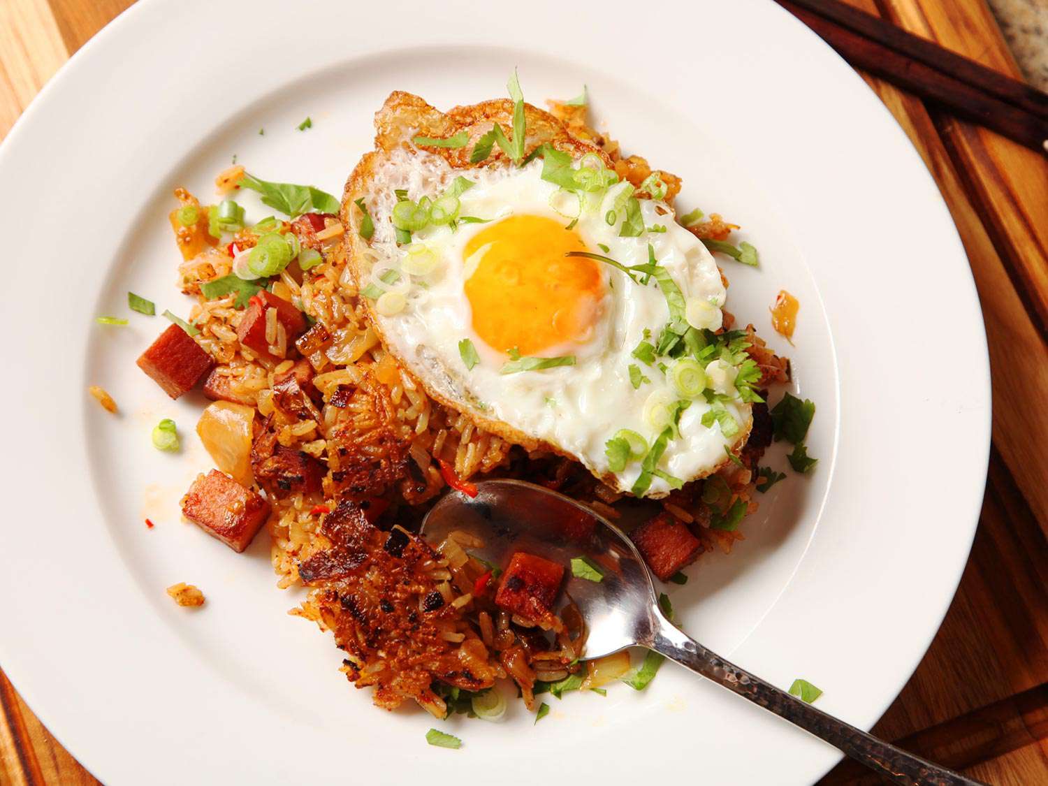 Crispy Kimchi and SPAM fried rice topped with fried egg and chopped scallion.