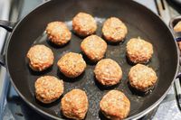 Meatballs cooking in a skillet