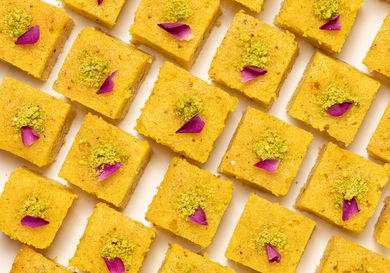 Baklava cake squares lined up on a white surface 