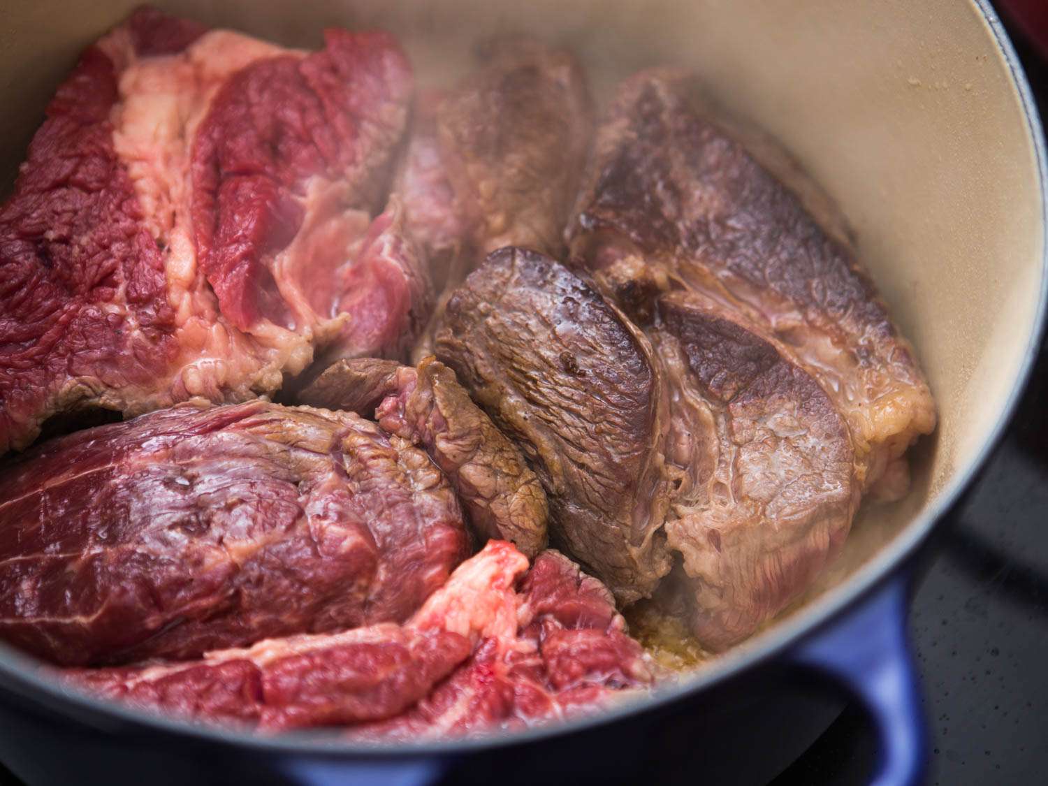Browning beef in a Dutch oven for boeuf Bourguignon. 