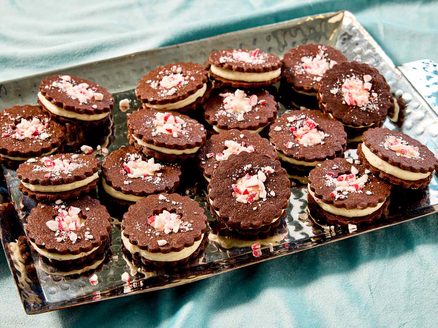 Tray of chocolate sandwich cookies topped with crushed peppermint