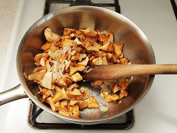 The trimmed chanterelles are added to the pan with the shallots and garlic.