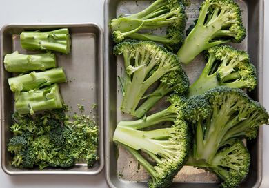 Broccoli cut into steaks, stems, and floret scraps.