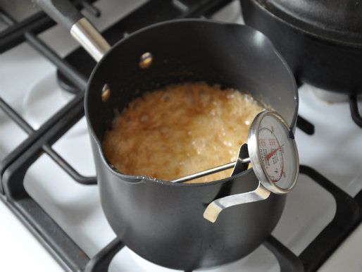 The cocoa-corn syrup mixture is boiled in a small saucepan affixed with a candy thermometer.
