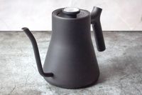 A gooseneck kettle on a countertop featuring a spout and handle for pouring beverages