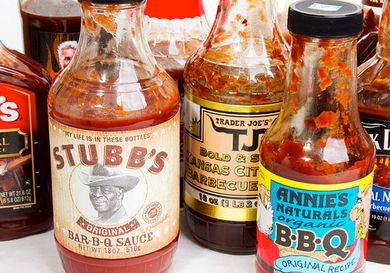 An assortment of bottled barbecue sauces on a table.