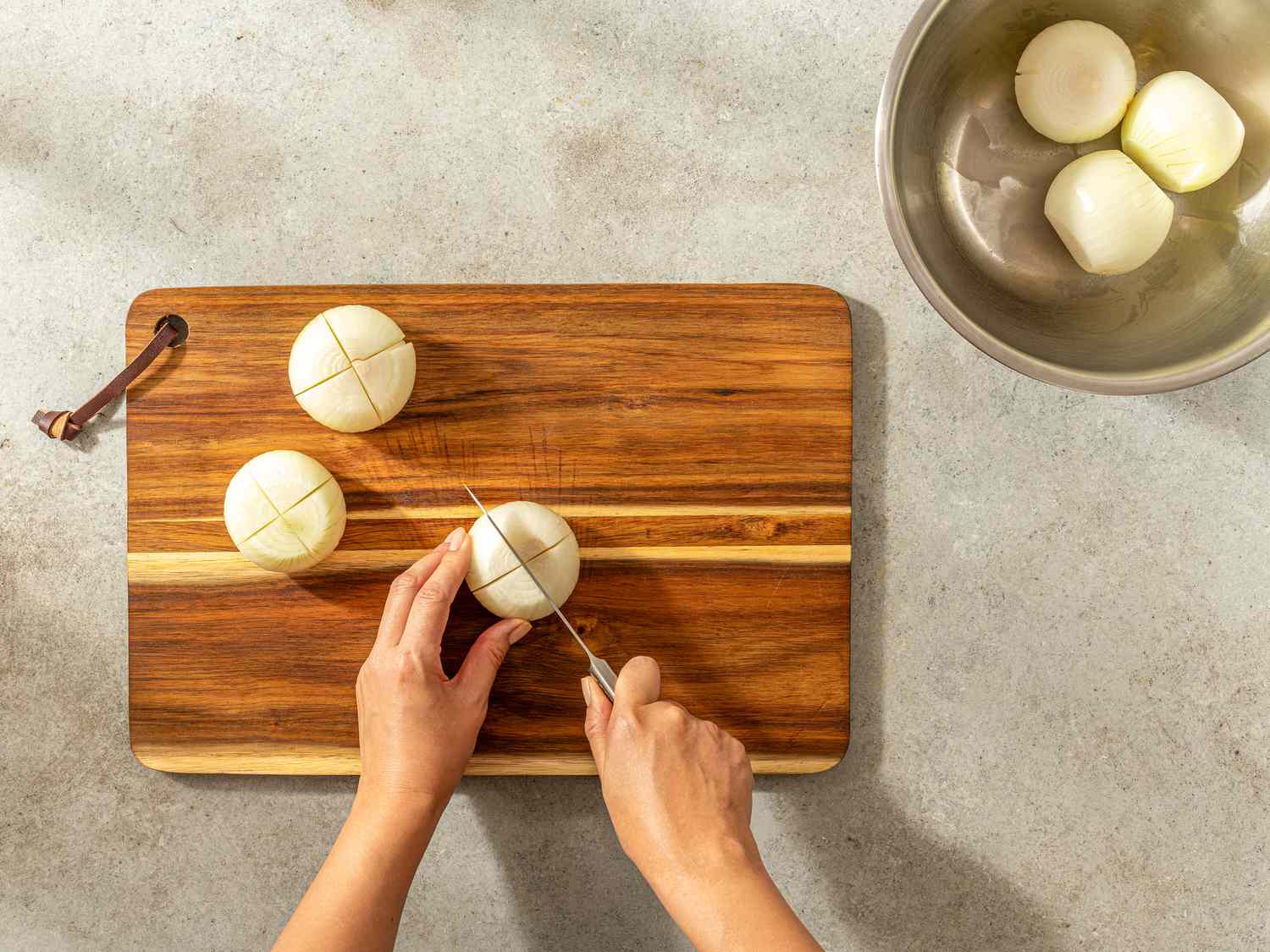 Overhead view of cutting an X into onions