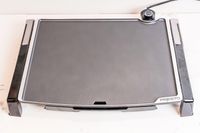 The Presto Tilt-N-Fold electric griddle on a white marble countertop