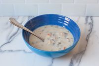 Le Creuset Stoneware Soup Bowl with soup on a counter top