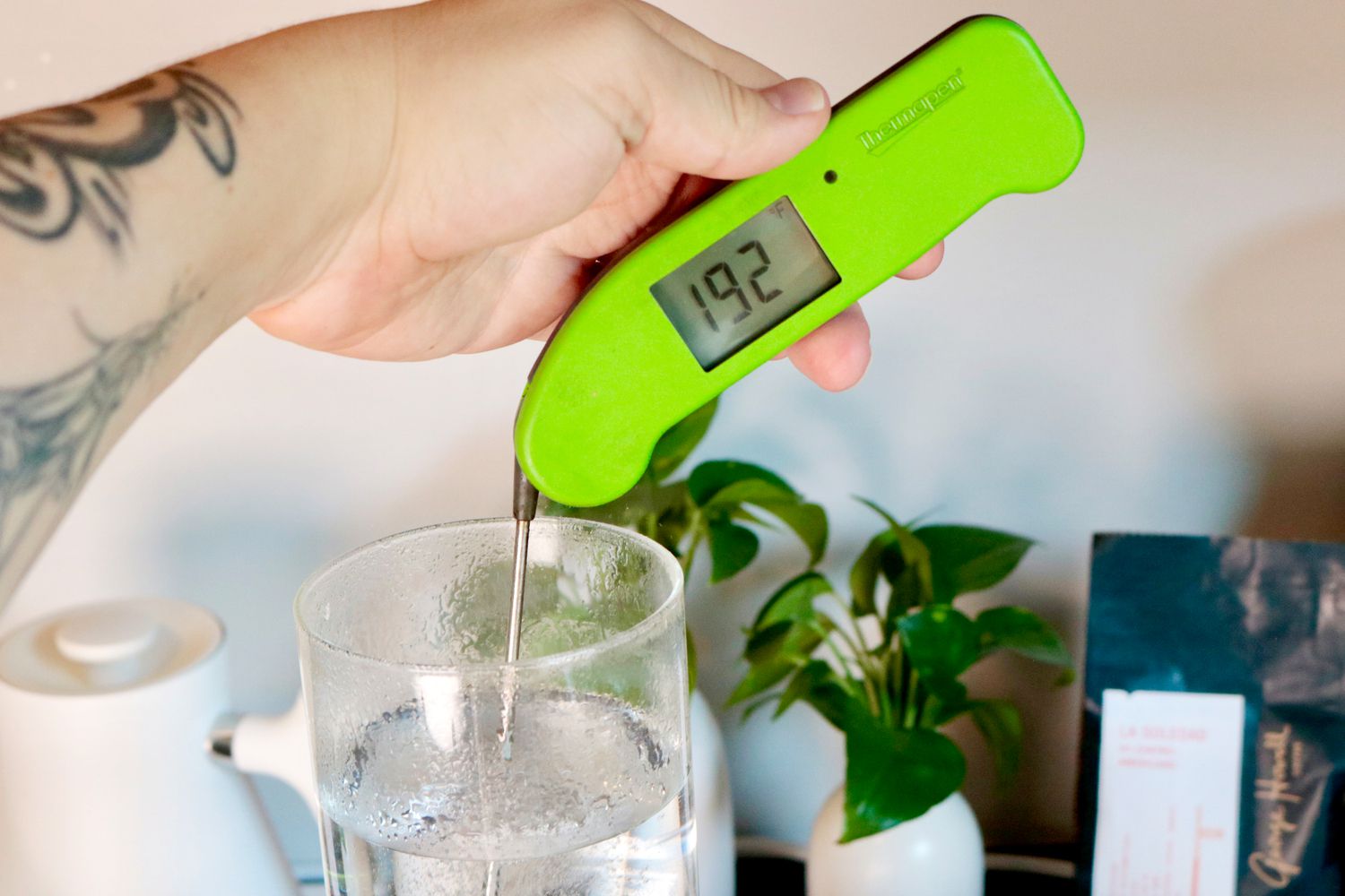 an instant-read thermometer taking the temperature of water