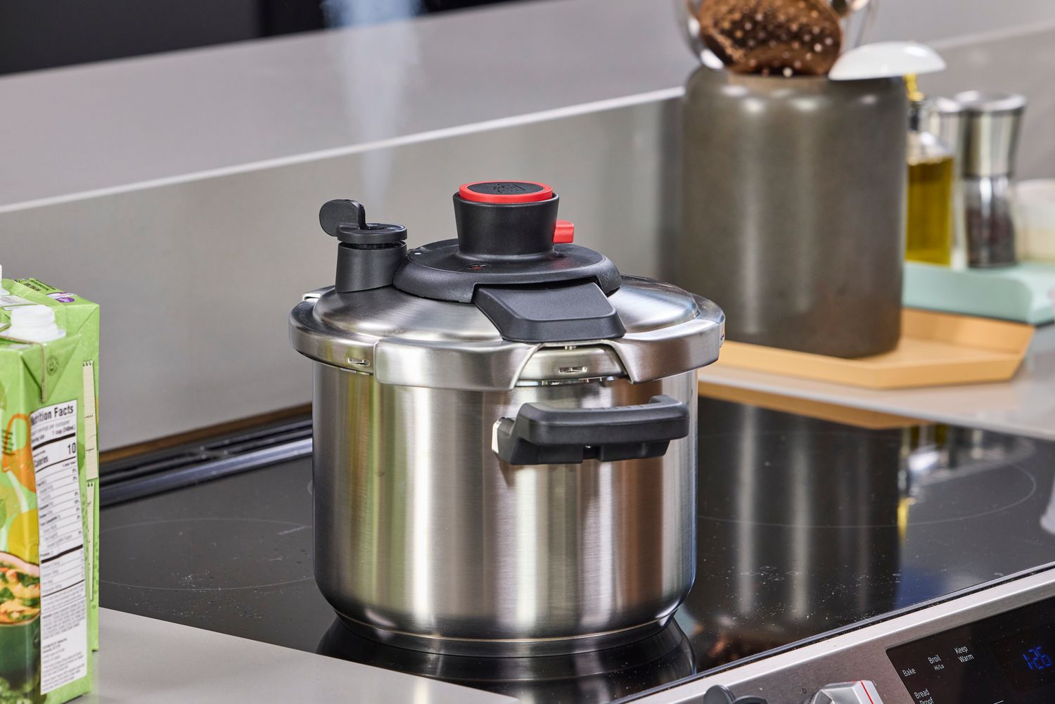 The T-Fal Clipso Pressure Cooker on an induction stove in a kitchen
