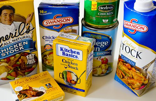 Containers of different store-bought chicken stocks.