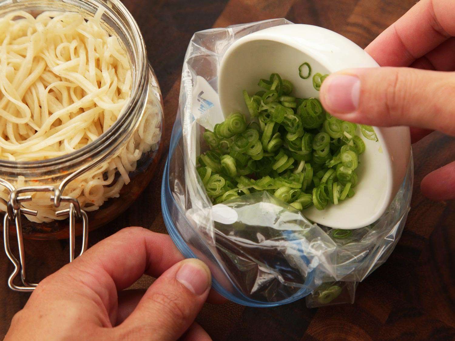 Sliced scallions are added to a zip-top bag.
