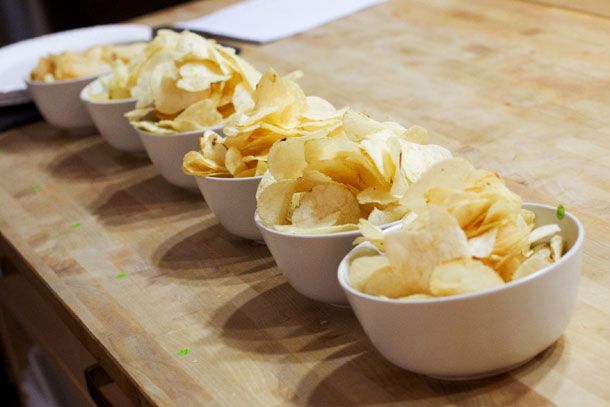 Six bowls of potato chips. 