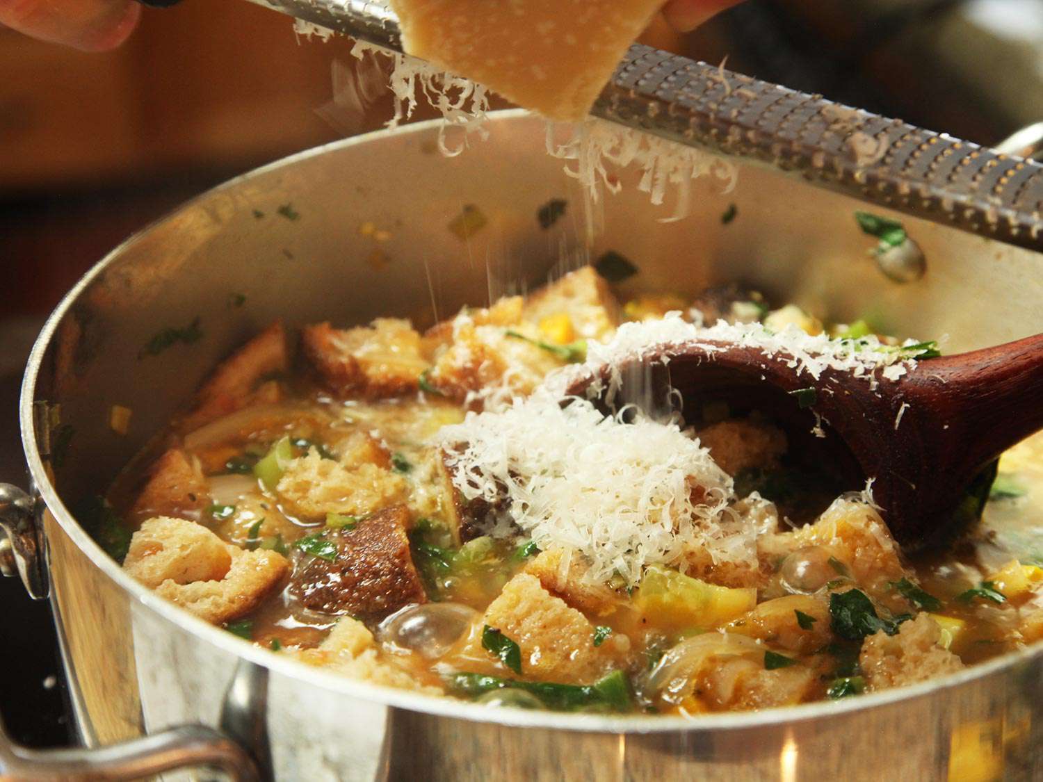 Parmesan is grated into the soup with a microplane.