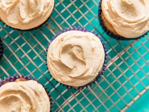 Overhead closeup of cupcakes on a cooling rack topped with easy peanut butter frosting.