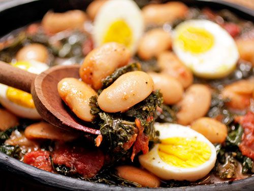 Closeup of the finished butter beans, studded with hard-boiled eggs and braised kale.