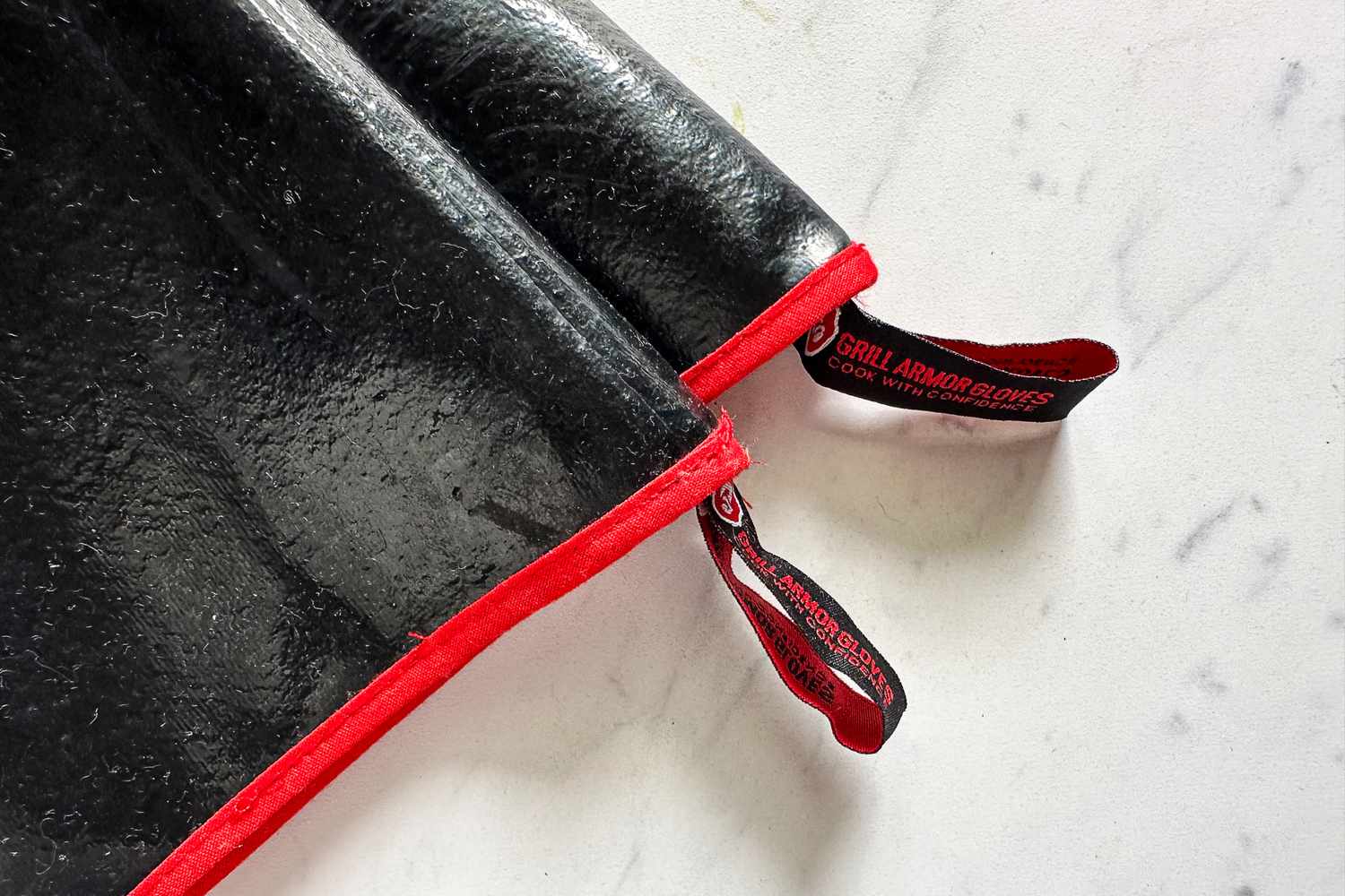 The branded tabs on the Grill Armor Gloves BBQ Waterproof Gloves