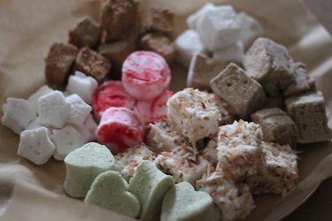 An assortment of flavored marshmallows, arranged in a bowl.