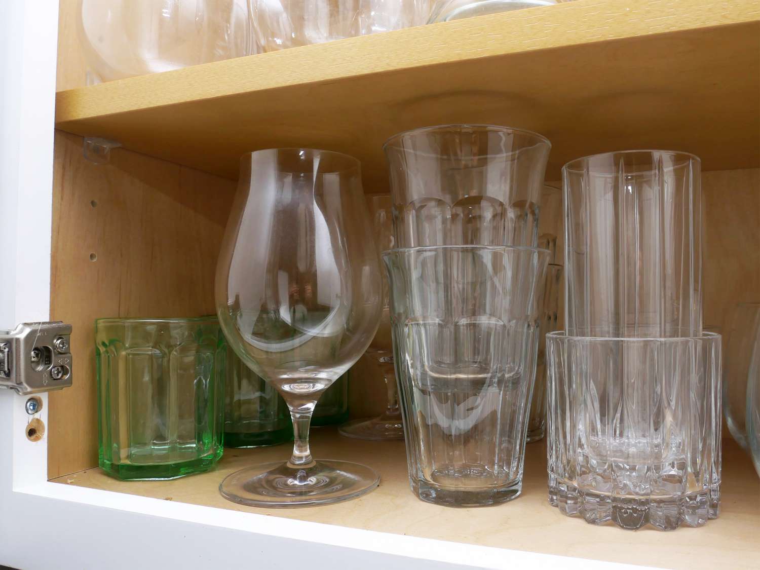 a closeup of more unusual glasses including beer glasses and green glass cups