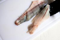 A person using the Victorinox Fillet Knife to slice a fish