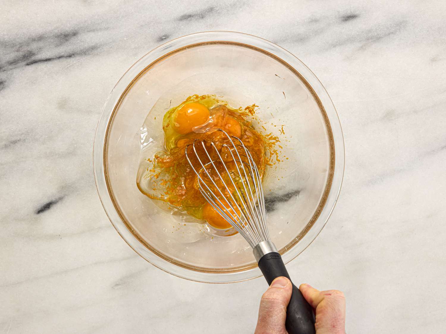 Overhead view of whisking eggs