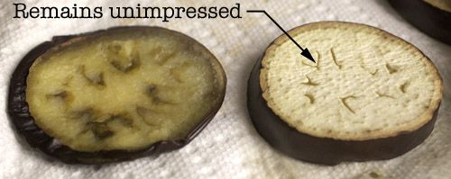 Two eggplant slices. One has been pressed to expel air, the other has not. The latter is labeled: "Remains unimpressed."