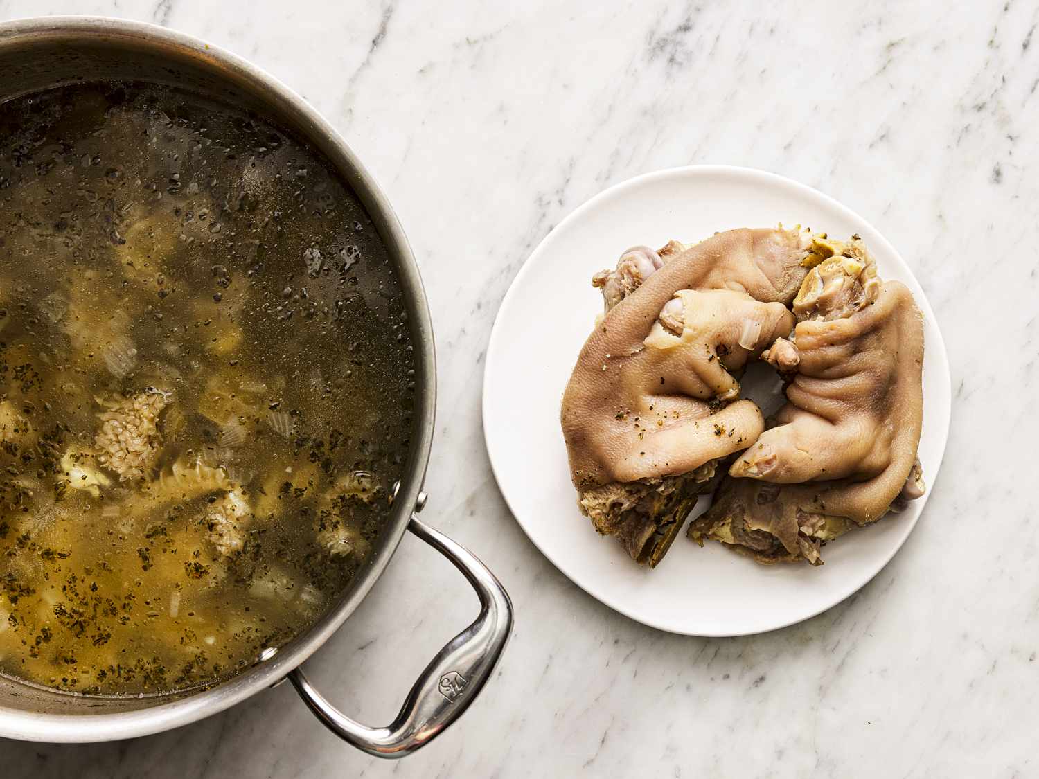 Trotters removed from pot onto a plate.