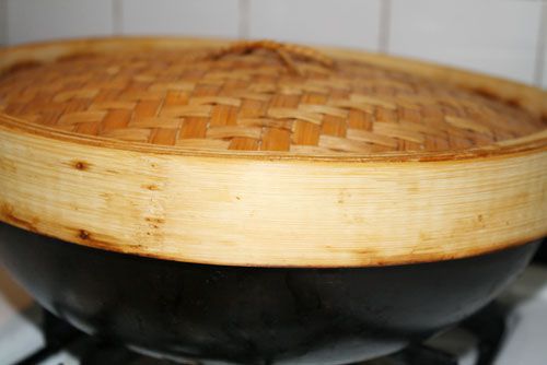 A bamboo lid over a wok.