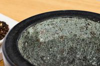 The ridged interior of a granite mortar and pestle.