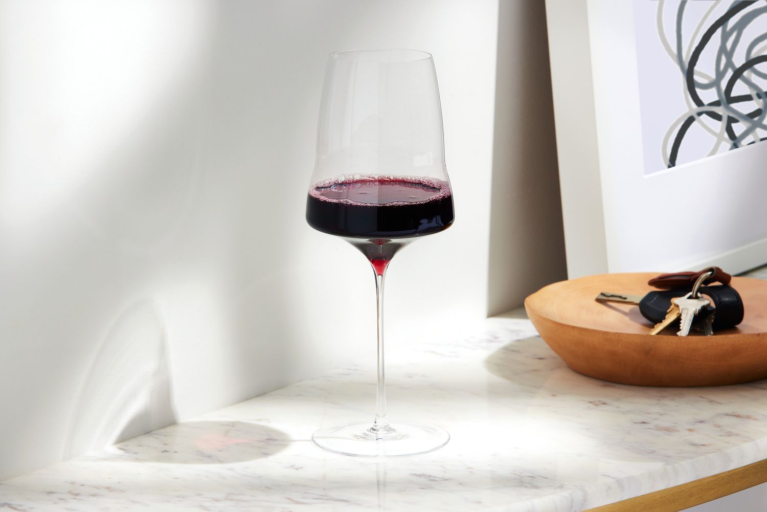 Josephinenhütte Josephine No. 2 Universal Wine Glass containing red wine on marble table