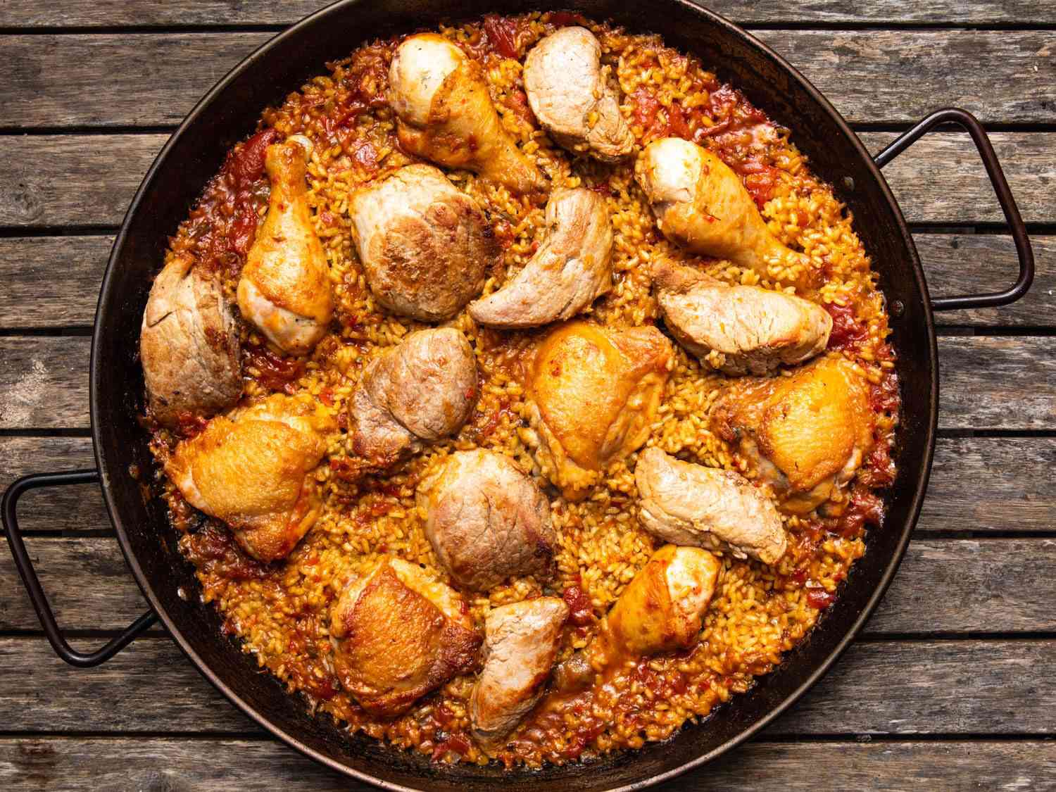 An all-meat (chicken and pork) paella shot from above.