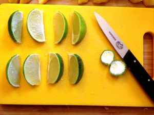 Lime wedges resting on a cutting board