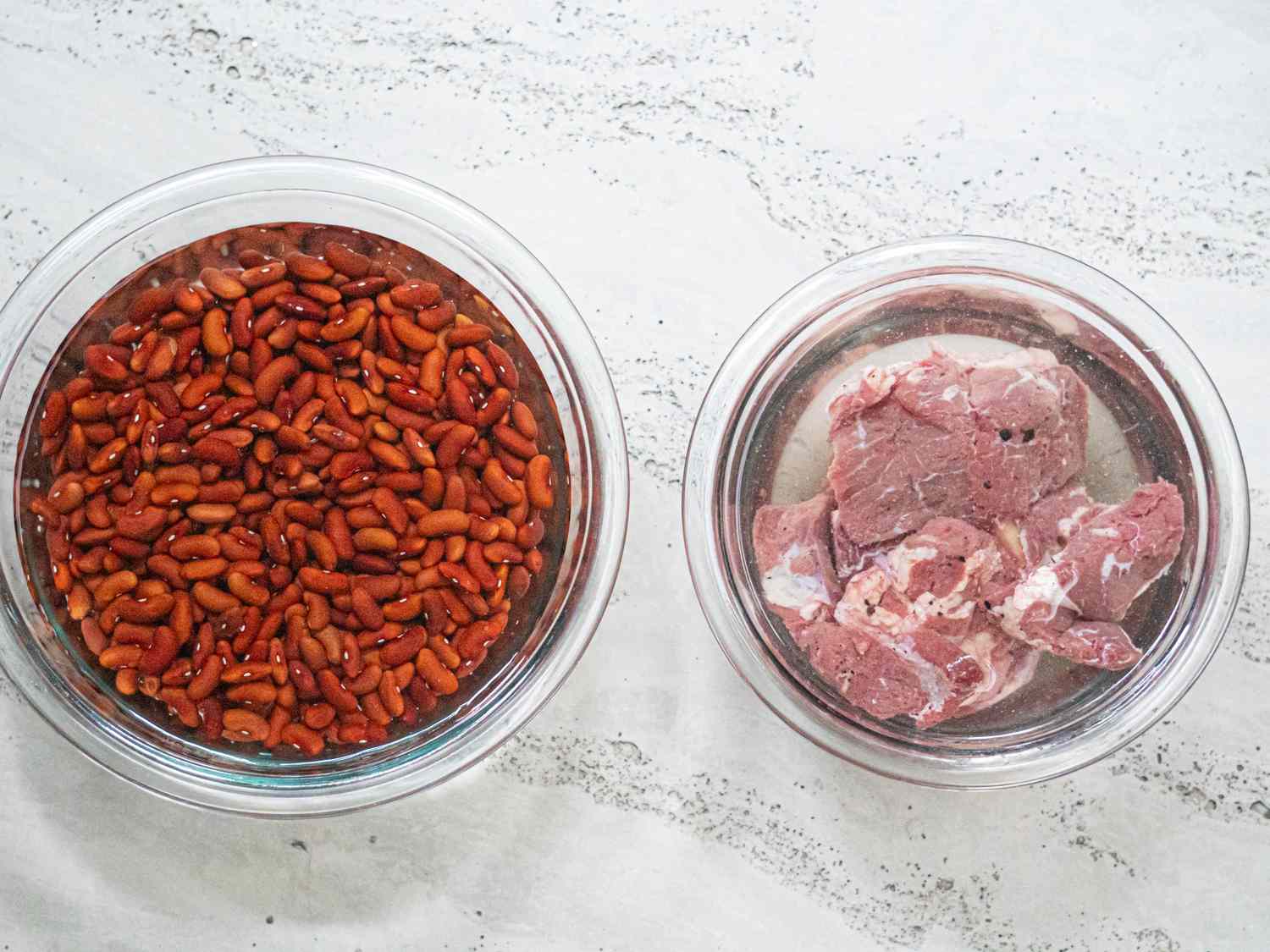 Overhead view of beans and beef in water 