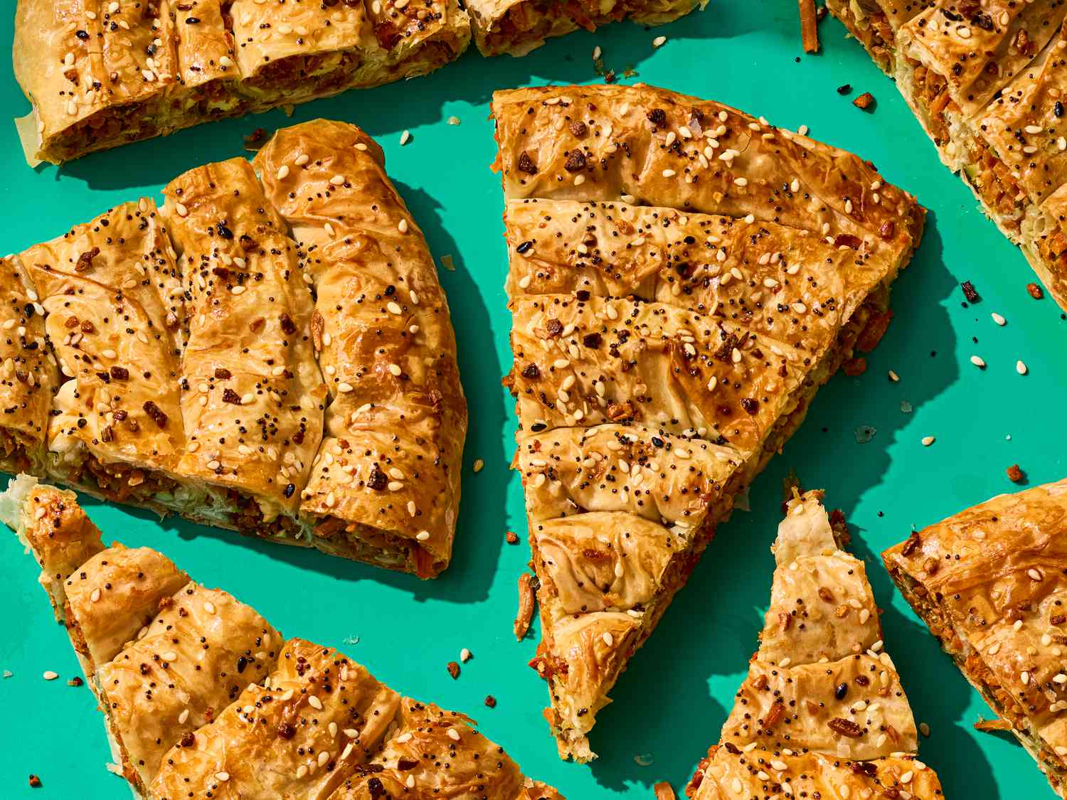 Slices of carrot and feta borek on a turquoise background