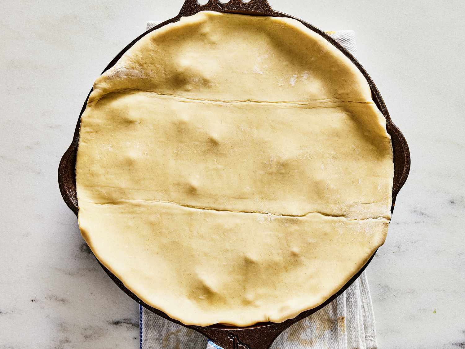 Pot pie pastry tucked into skillet 