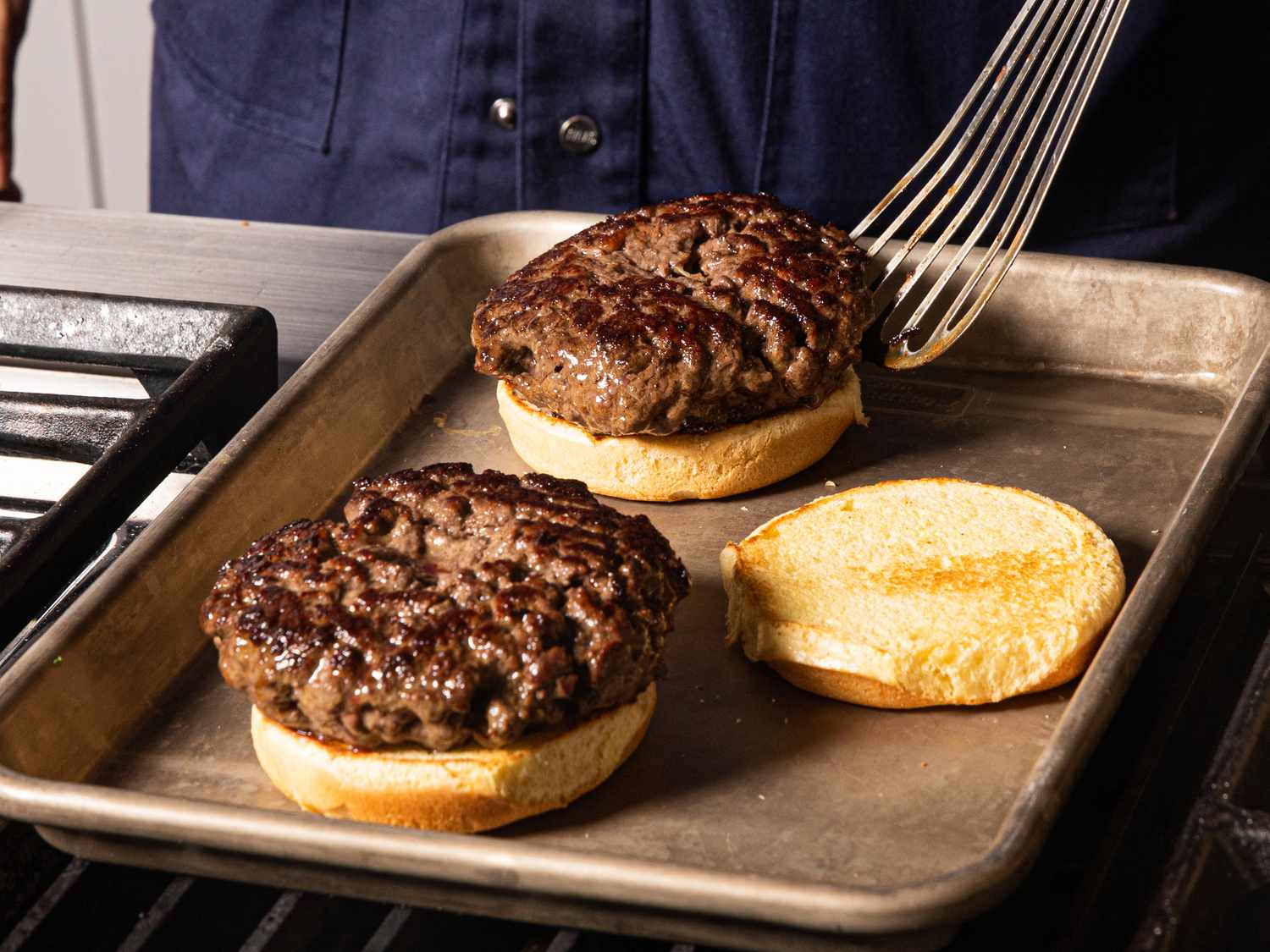 Side view of placing patties on buns