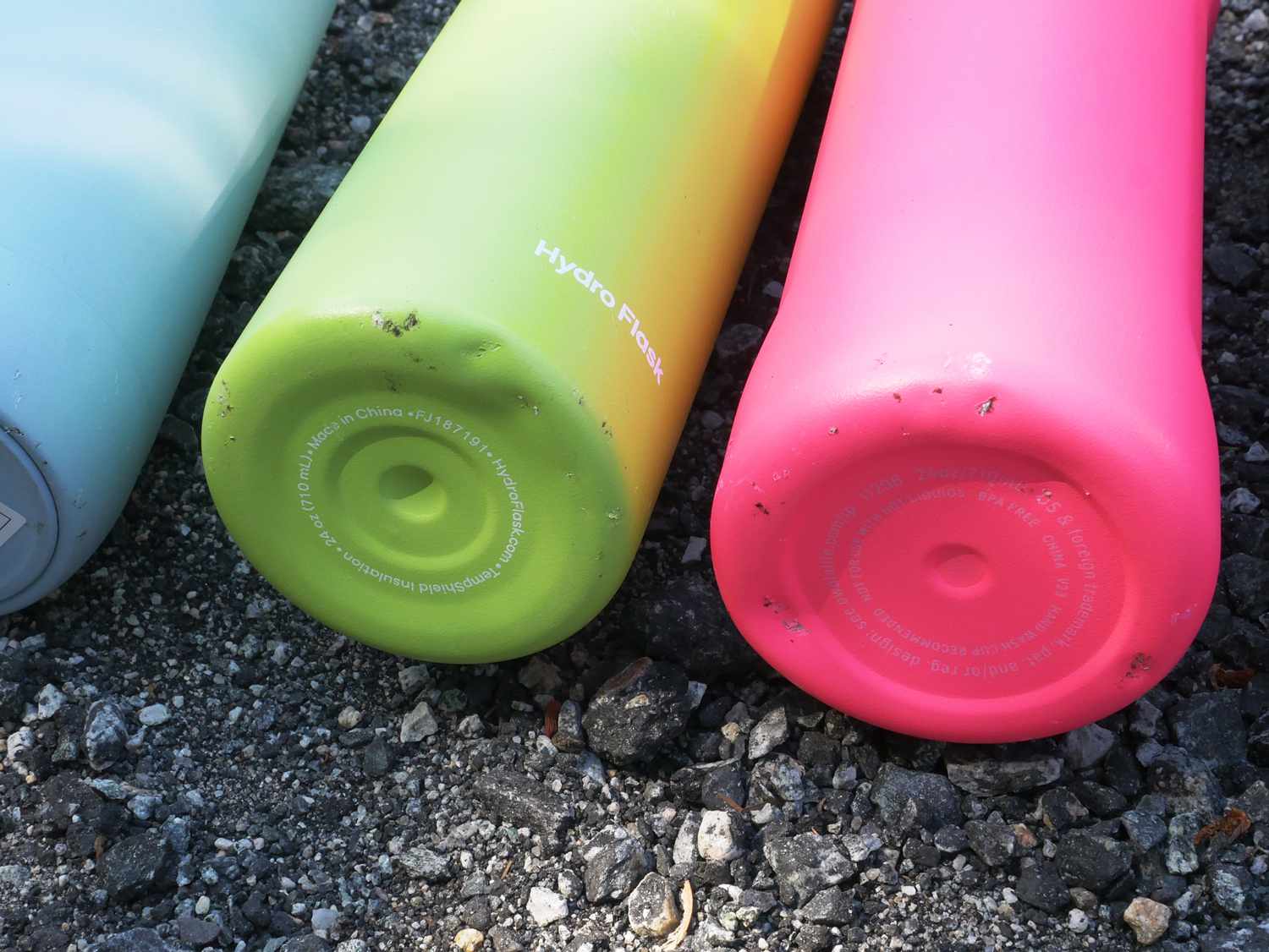 Closeup of dents on the bottoms of 3 stainless steel water bottles