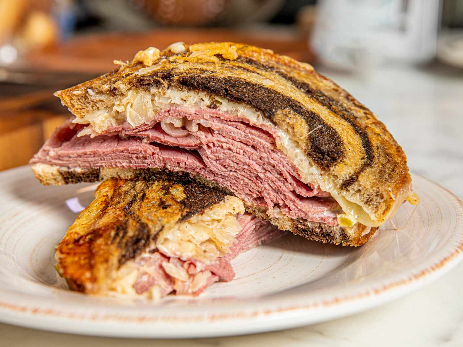 Finished Reuben cut in half on a plate 