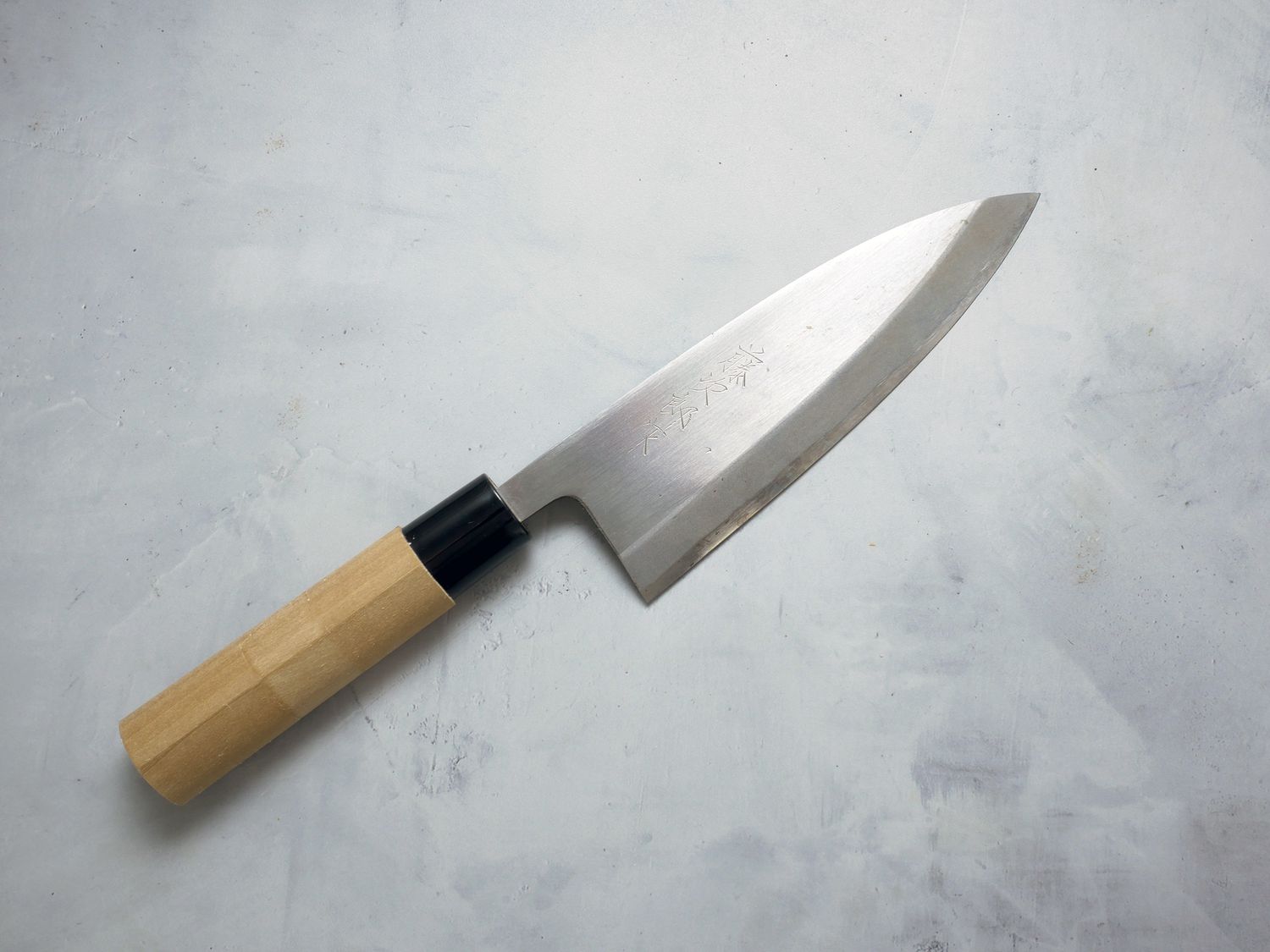 Tojiro deba on grey concrete surface