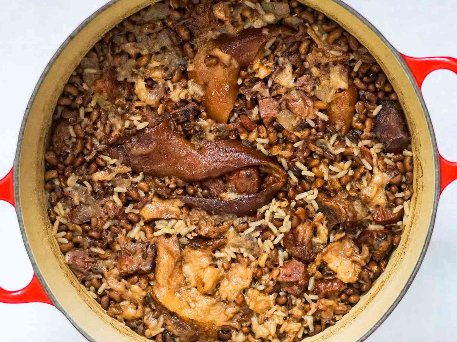 Overhead of a cooked Hoppin' John in a Dutch oven. 