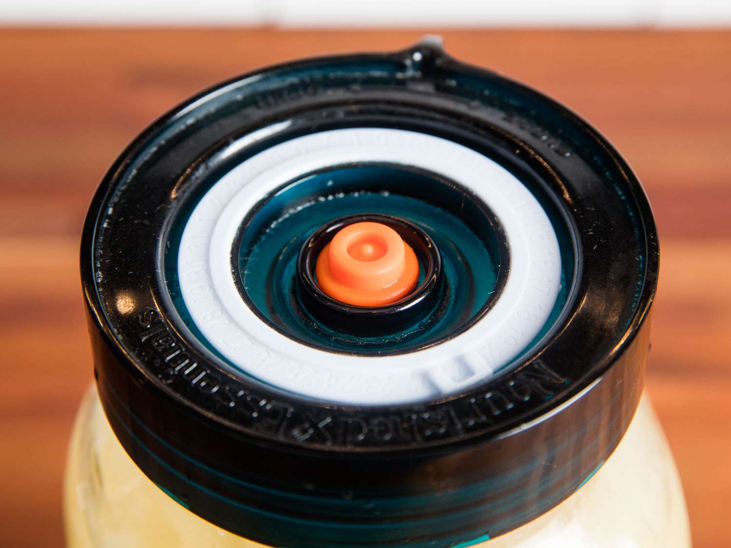 A canning jar fitted with an air lock