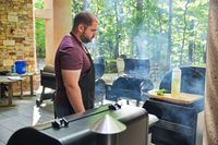 Person looking at the Traeger TBB86RLG Timberline Pellet Grill