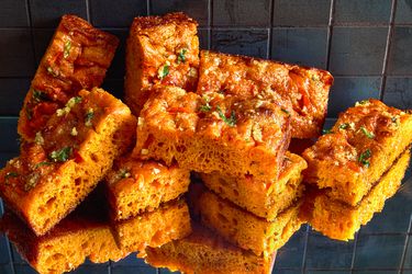 Slices of carrot focaccia bread on a reflective surface