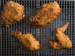 Fried chicken on a wire rack set inside a baking sheet