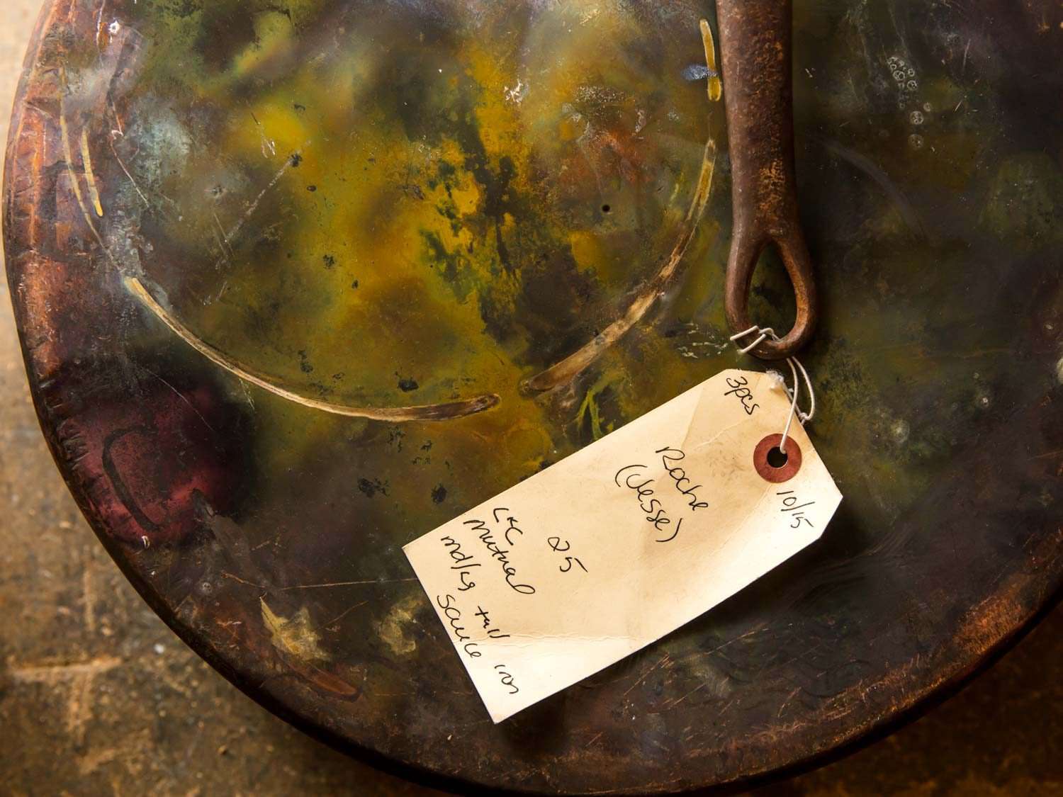 The seam on the bottom of a large copper pot