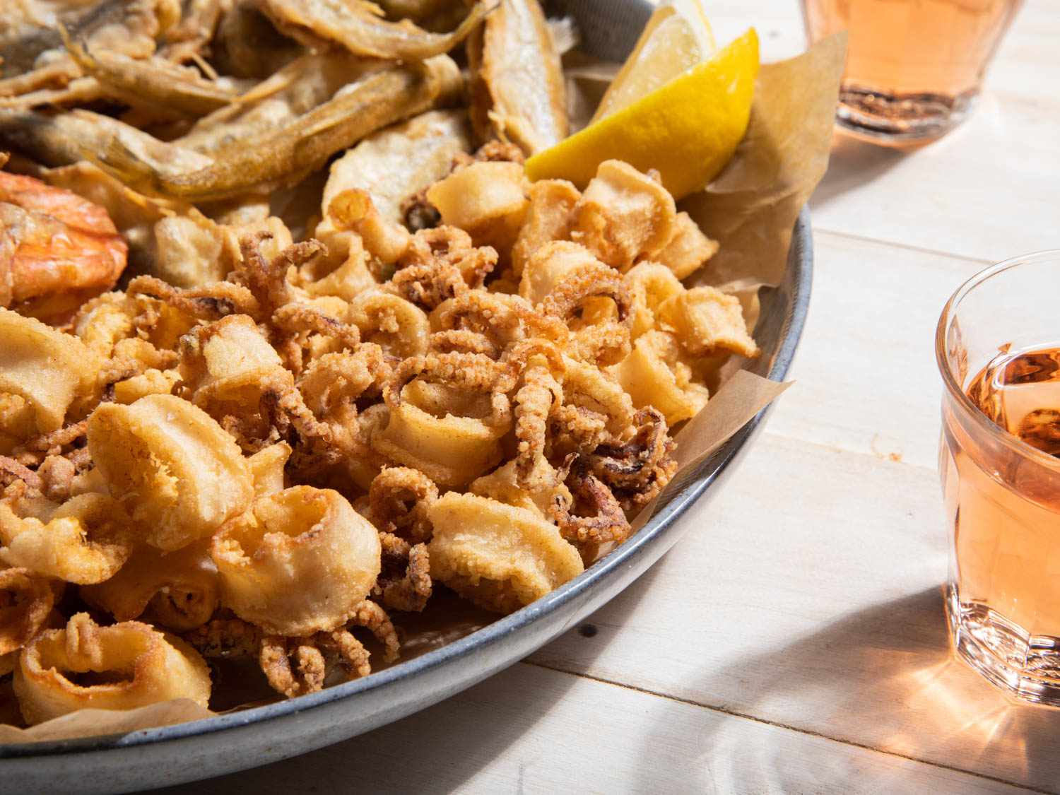 A closeup of fried calamari as part of a fritto misto platter.