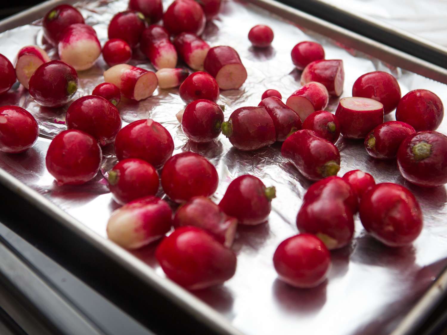 The prepped radishes on a foil-lined rimmed baking sheet.