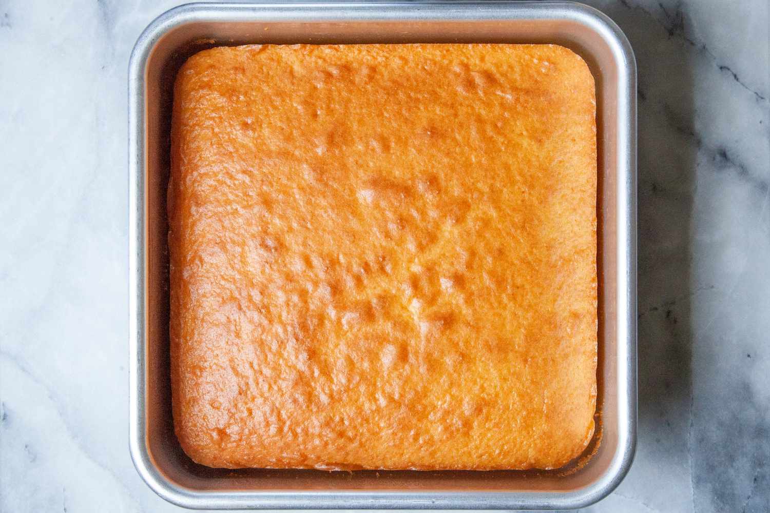 The Nordic Ware square baking pan with a yellow cake baked in it